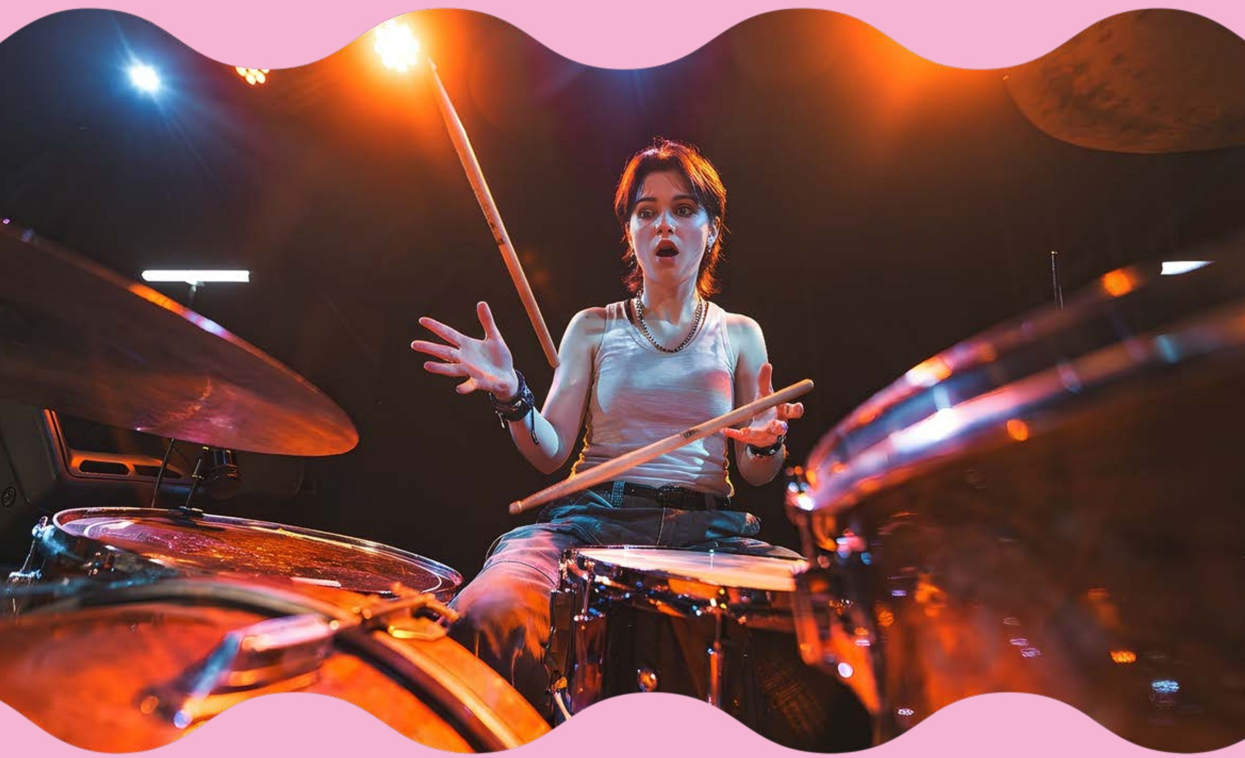 Drummer mid-performance gripping Nojsy sticks